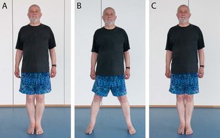 A man standing with feet together, then feet apart after stepping sideways with one foot, then feet together after stepping sideways with the other foot.